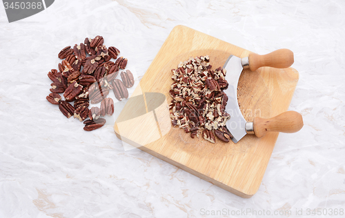 Image of Toasted pecans with a rocking knife 