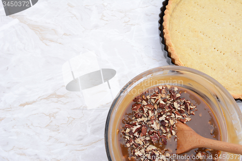 Image of Baking pecan pie - pie filling and pastry crust