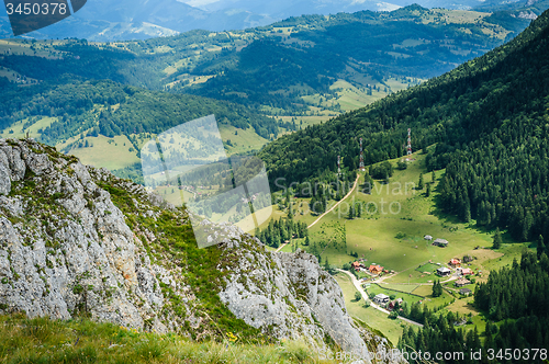 Image of Single house on a meadow in mountains