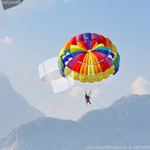 Image of Parasailing in a blue sky near sea beach