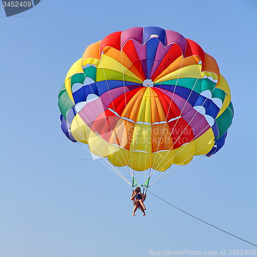 Image of Parasailing in a blue sky near sea beach