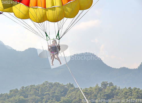 Image of Parasailing in a blue sky near sea beach