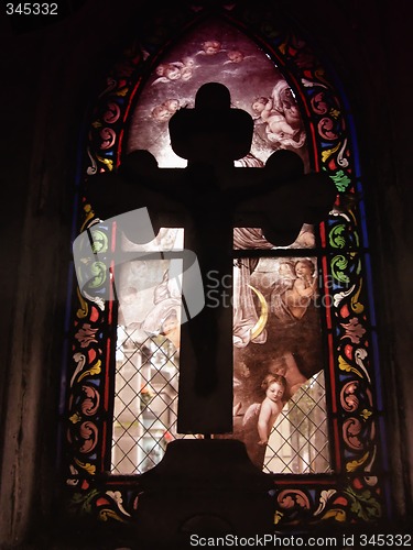 Image of Cross in front of a stained glass