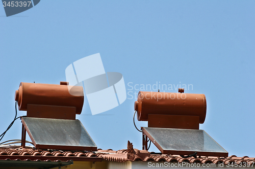Image of Solar pannels on a roof house in  Peloponese in greece in the su