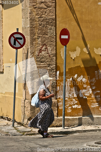Image of Traffic sign and topurist in Peloponese in greece in the summer