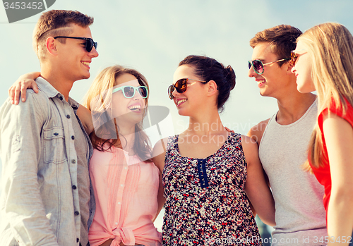 Image of group of smiling friends in city