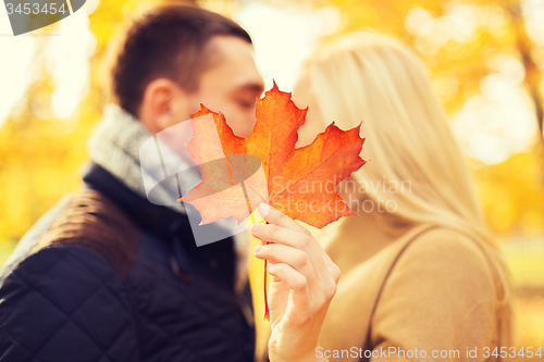 Image of close up of couple kissing in autumn park