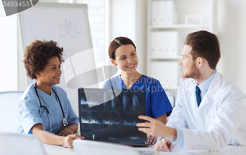 Image of group of happy doctors discussing x-ray image