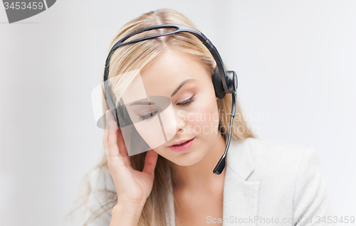 Image of female helpline operator with laptop