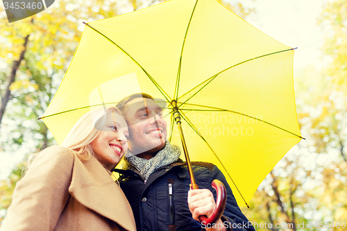 Image of smiling couple hugging in autumn park