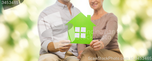 Image of close up of happy senior couple with green house