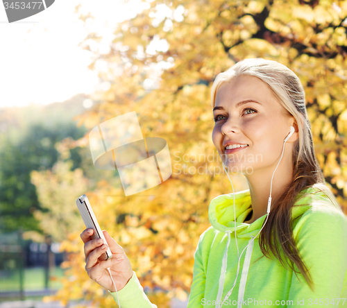 Image of woman listening to music outdoors