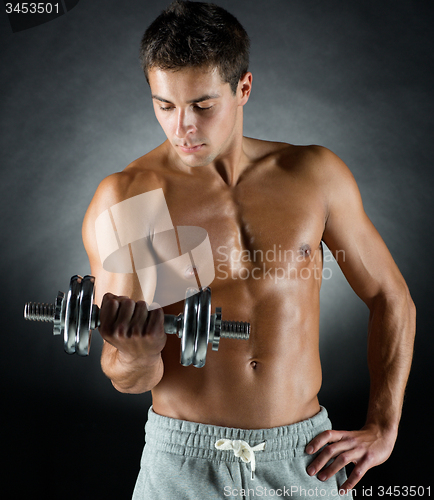 Image of young man with dumbbell