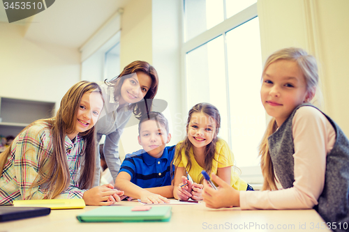 Image of group of school kids writing test in classroom