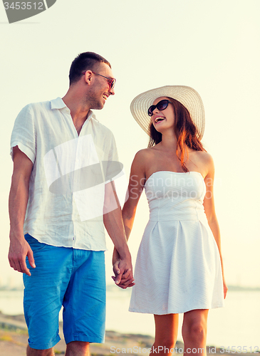 Image of smiling couple walking outdoors