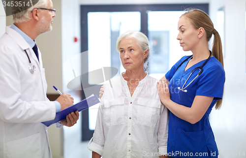 Image of medics and senior patient woman at hospital