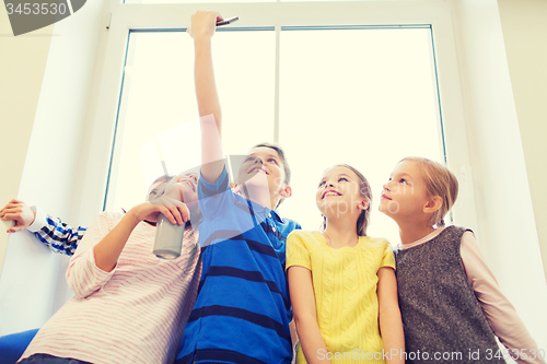 Image of group of school kids with smartphone and soda can