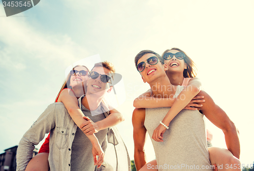 Image of smiling couple having fun in city