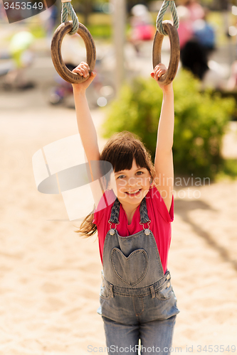 Image of happy little girl on children playground