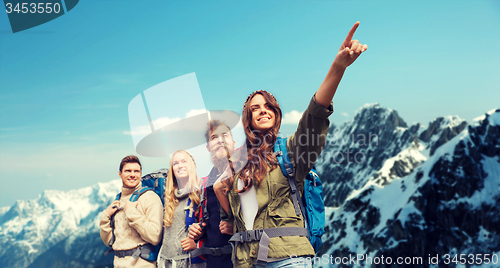 Image of group of smiling friends with backpacks hiking