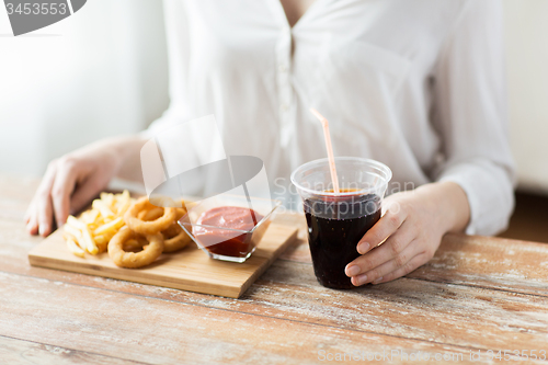 Image of close up of woman with snacks and cola