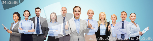 Image of group of happy businesspeople showing thumbs up
