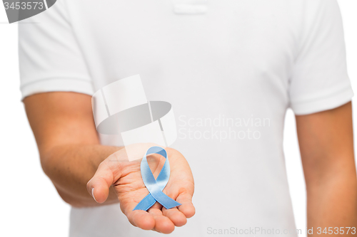 Image of hand with blue prostate cancer awareness ribbon