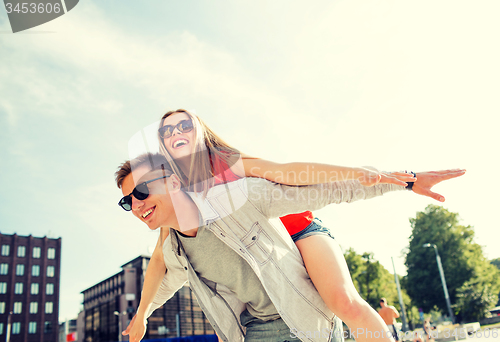 Image of smiling couple having fun in city