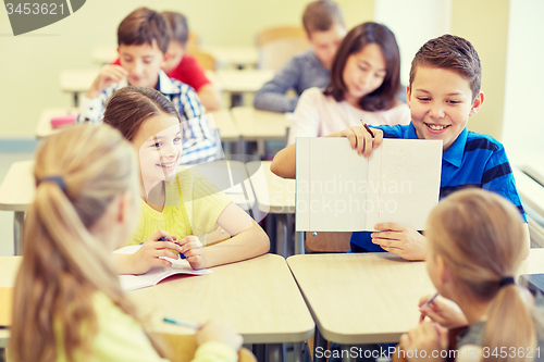 Image of group of school kids writing test in classroom