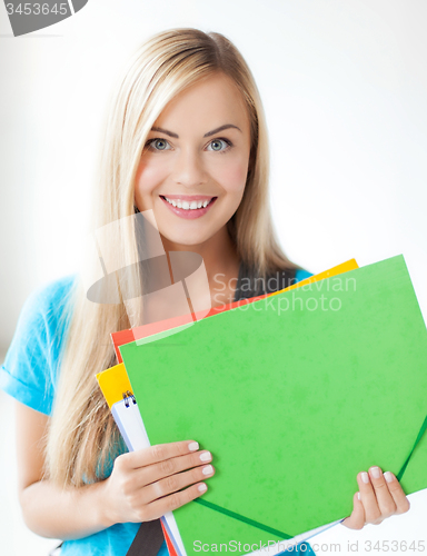 Image of smiling student with folders