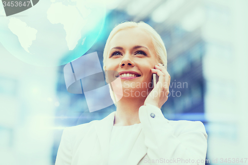 Image of smiling businesswoman with smartphone outdoors