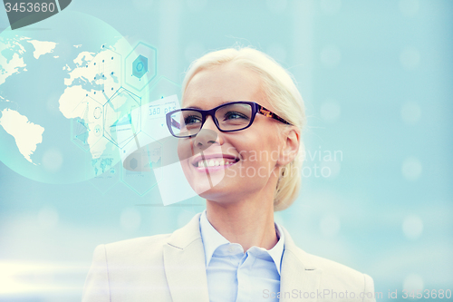 Image of young smiling businesswoman in eyeglasses outdoors