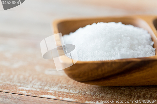 Image of close up of white salt heap in wooden bowl