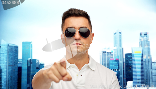 Image of man in sunglasses pointing finger on you