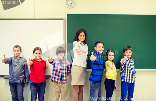 Image of group of school kids and teacher showing thumbs up