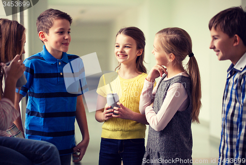 Image of group of school kids with soda cans in corridor