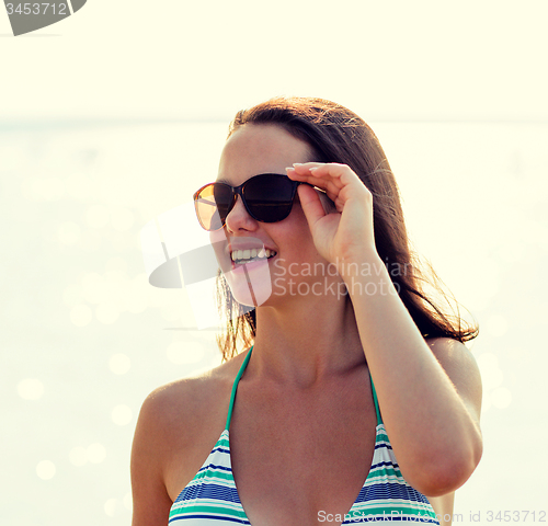 Image of smiling teenage girl in sunglasses