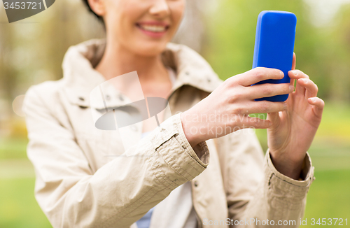 Image of close up of woman taking picture with smartphone