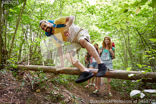 Image of group of smiling friends with backpacks hiking