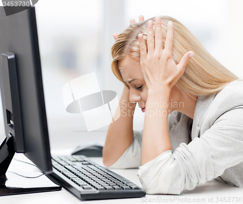 Image of stressed woman with computer