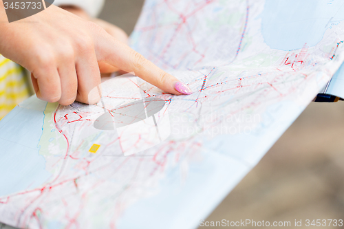 Image of close up of woman hand pointing finger to map