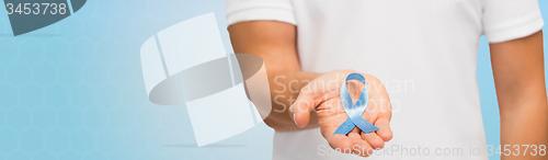 Image of hand with blue prostate cancer awareness ribbon