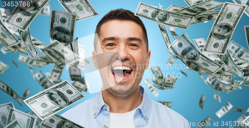 Image of laughing man with falling dollar money