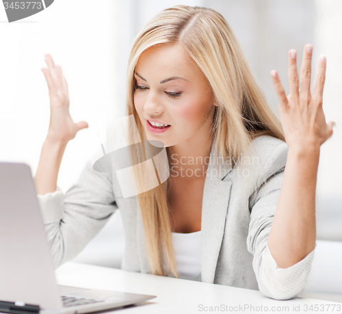 Image of angry woman with laptop