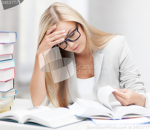 Image of student with books and notes