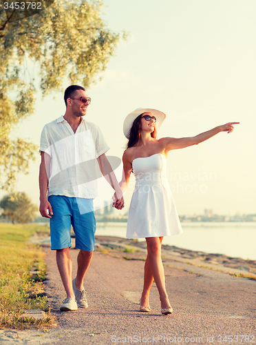 Image of smiling couple walking outdoors