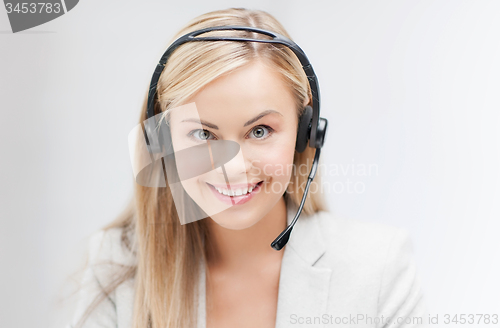 Image of friendly female helpline operator with laptop