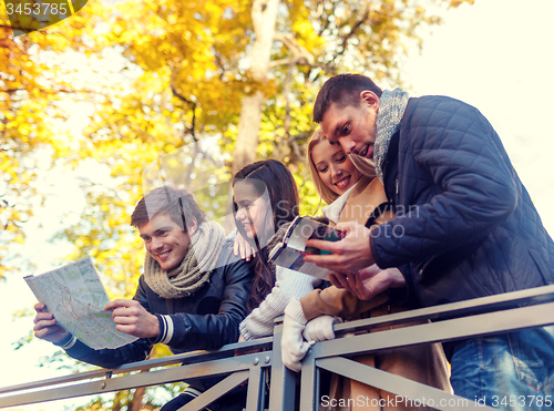 Image of group of friends with map outdoors