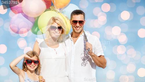 Image of happy family with balloons over blue lights