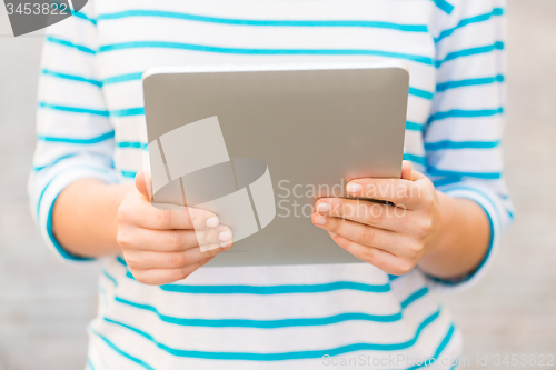 Image of close up of woman with tablet pc outdoors